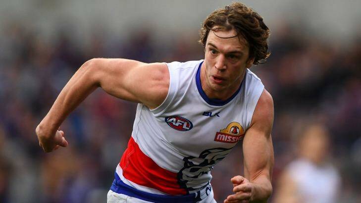 Focused: Liam Picken commits to chasing the ball for the Dogs. Photo: AFL Media/Getty Images