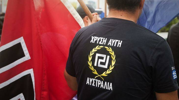 A protester wearing a Golden Dawn T-shirt, next to a swastika flag in Brisbane, Australia. Photo: Naz Mulla/File