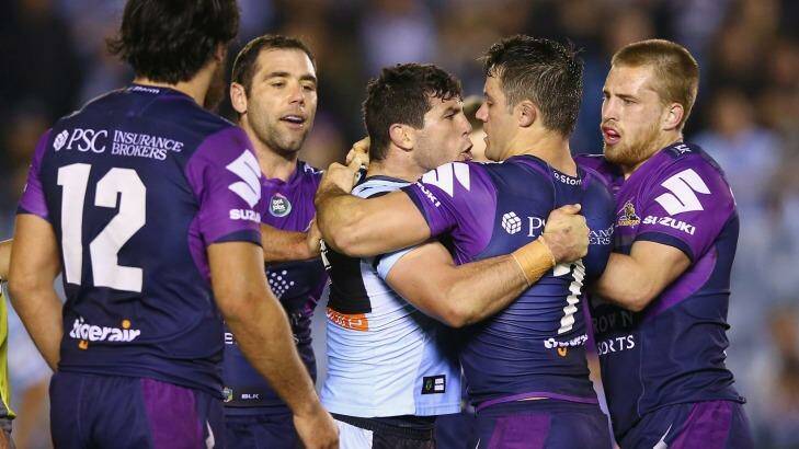 Getting under the opposition's skin: Michael Ennis and Cooper Cronk scuffle. Photo: Mark Kolbe