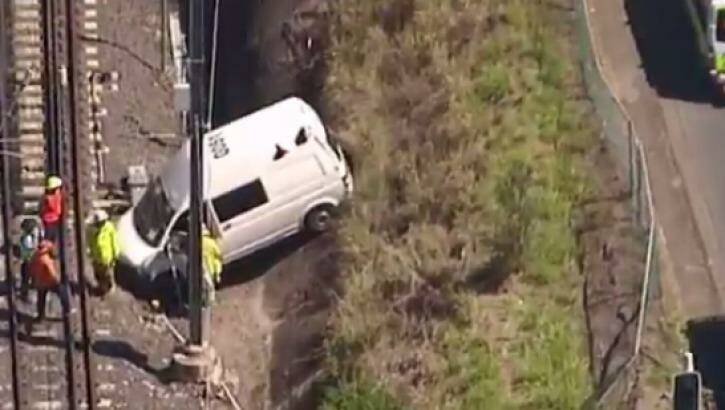 The van crashed through a fence onto train tracks at Fairfield. Photo: Nine News Brisbane