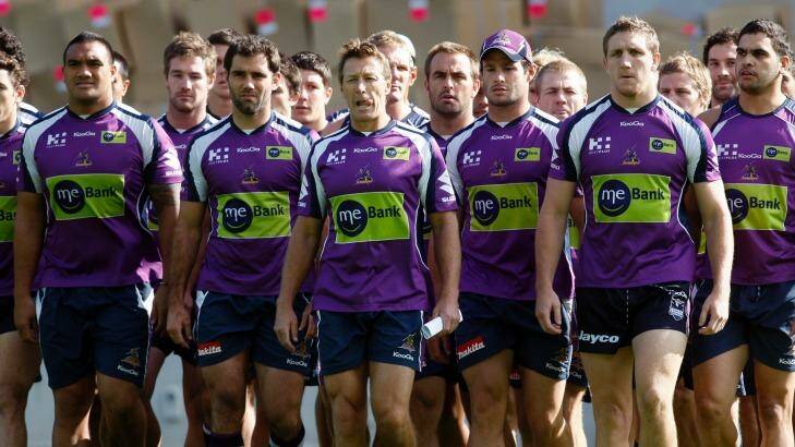 Purple pain: Storm players and coach Craig Bellamy make their defiant walk to waiting media after the scandal broke. Photo: Paul Rovere