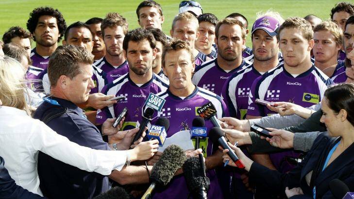 Surrounded by all 22 players,  Craig Bellamy reads a statement to the media in April 2010  regarding the future of the club in light of the penalties handed out by the NRL. Photo: PAUL ROVERE