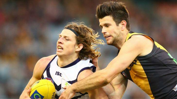 Out of grasp: Nathan Fyfe slips clear of Trent Cotchin. Photo: Scott Barbour