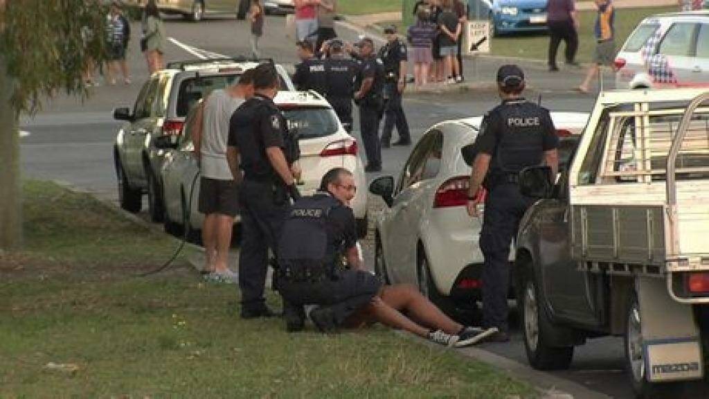 Police subdue a man after the league grand-final. Photo: The Queensland Times