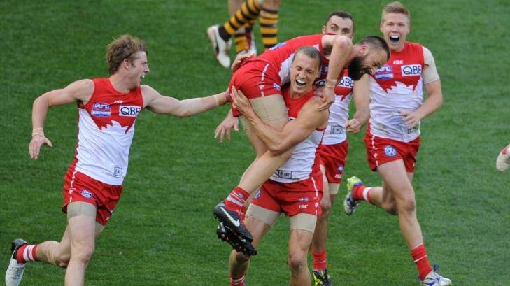 In the Nick of time: Swans players rush to congratulate Nick Malceski for his last-minute goal in the 2012 grand final. Photo: Justin McManus