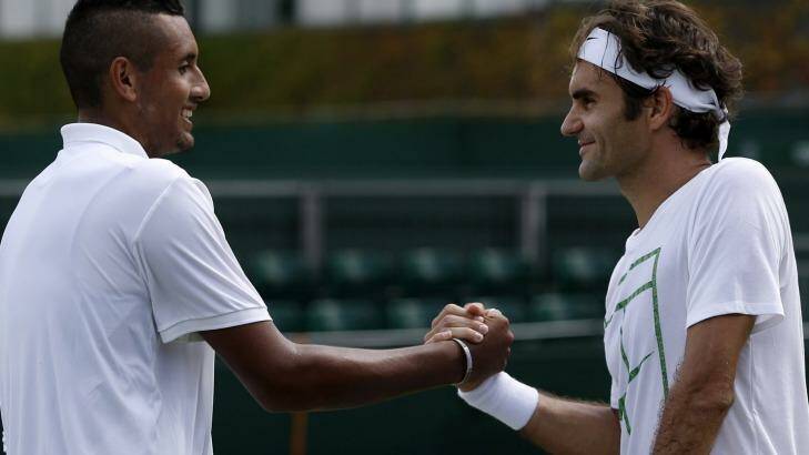 Anti-Fed: Nick Kyrgios shakes hands with Roger Federer after a practice session at Wimbledon. Photo: Adrian Dennis