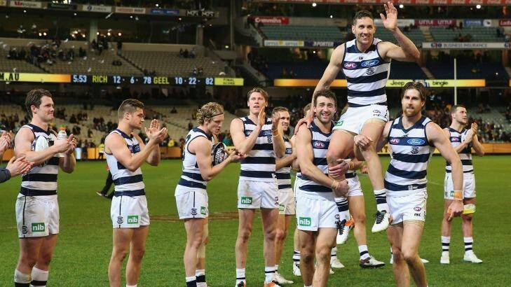 Carried away: teammates honour Harry Taylor after his 200th game for Geelong. Photo: Michael Dodge