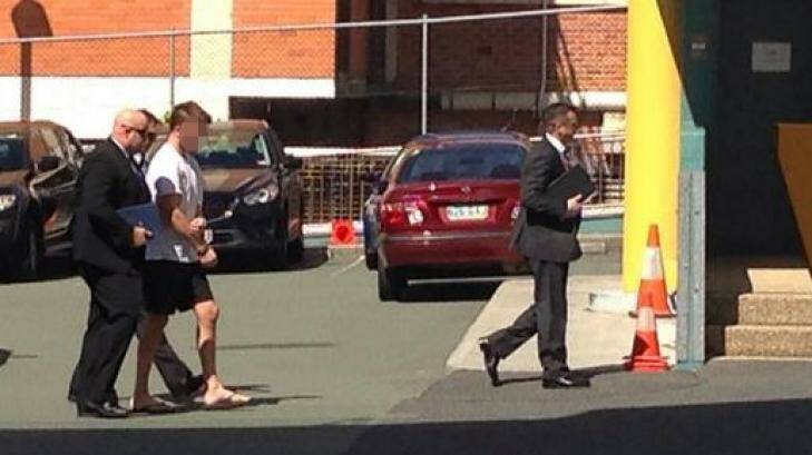 Detectives lead a handcuffed Gable Tostee to the watchhouse. Photo: Nine News