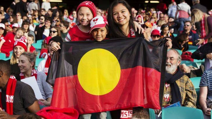 Proud Aussies: Sydney Swans supporters hold a flag for Adam Goodes. Photo: James Brickwood