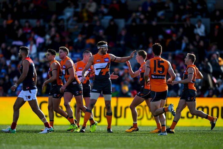 Shane Mumford of the Giants celebrates with team mates after scoring a goal during the Round 20 AFL match between the Greater Western Sydney (GWS) Giants and the Melbourne Demons at Manuka Oval in Canberra, Saturday, August 5, 2017. (AAP Image/Lukas Coch) NO ARCHIVING, EDITORIAL USE ONL