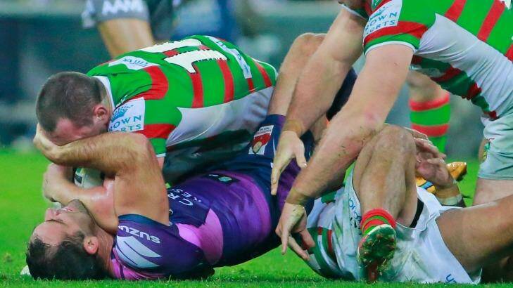 MELBOURNE, AUSTRALIA - MAY 16:  Cameron Smith of the Storm kicks Issac Luke of the Rabbitohs whilst being tackled during the round 10 NRL match between the Melbourne Storm and the South Sydney Rabbitohs at AAMI Park on May 16, 2015 in Melbourne, Australia.  (Photo by Scott Barbour/Getty Images) Photo: Scott Barbour