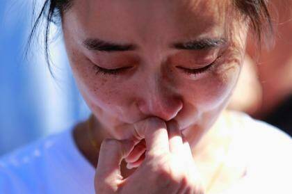 A family member of a passenger onboard the MH370 cries at a temple in Beijing in September, 2014.  Photo: KIM KYUNG-HOON / Reuters