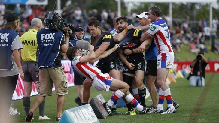 Boiling over: The tussle spills over the sideline. Photo: Darren Pateman 