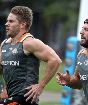 Gearing up for the season ahead: James Tedesco, centre, goes through his paces at Wests Tigers training at Concord on Monday. Photo: Ben Rushton