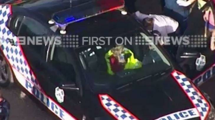 Jocelyn Lewis, whose disappearance sparked a massive search effort, is pictured in the front seat of a police car. Photo: Nine News Gold Coast