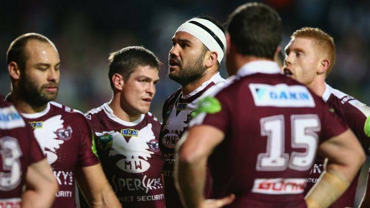 Dejected: Manly players they watch a replay on the big screen during the round 19 loss to the North Queensland Cowboys at Brookvale Oval. Photo: Mark Kolbe