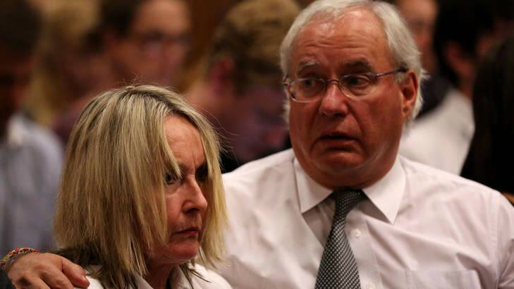 June Steenkamp (left), Reeva Steenkamp's mother, is comforted by a relative after her dead daughter's picture was shown on screen. Photo: AFP Photo