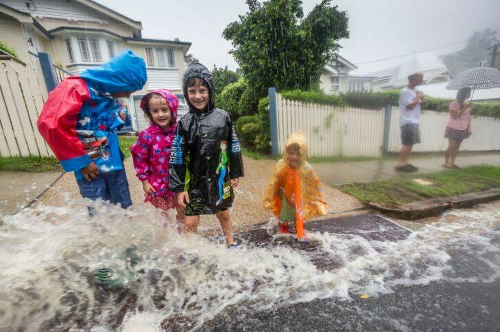 BRISBANE, AUSTRALIA - MARCH 30:  A family plays in the rain from ex-cyclone Debbie in Newmarket on March 30, 2017 in Brisbane, Australia.  (Photo by Glenn Hunt/Fairfax Media) Photo: Glenn Hunt