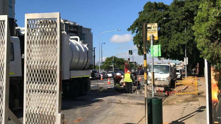 Queensland Urban Utilities workers fix a burst water main on Kingsford Smith Drive. Photo: Gabby Arena-McKay
