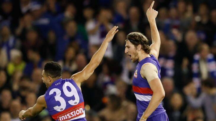 Unleashed: Bulldogs Jason Johannisen and Marcus Bontempelli celebrate after beating the Roos. Photo: Adam Trafford/AFL Media