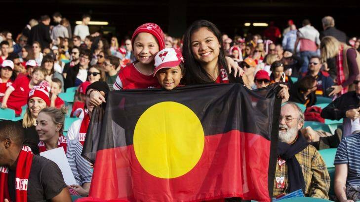 Proud Aussies: Sydney Swans supporters hold a flag for Adam Goodes. Photo: James Brickwood
