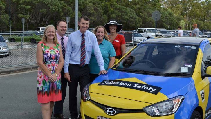 Brisbane City Council's Cr Angela Owen Taylor, Cr Adrian Schrinner, Lord Mayor Graham Quirk, Madonna Stewart from the P&C Association of Queensland LD and Calamvale Community College principal Lisa Starmer with a new parking vehicle which will be used to manage traffic at about 300 Brisbane schools. Photo: Brisbane City Council