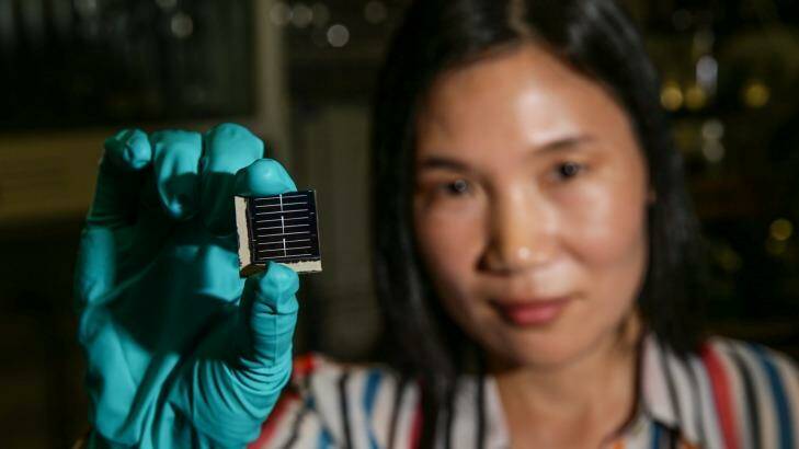 Hao Xiaojing, a lead researcher at UNSW, holds one of the new solar cells her team has developed.  Photo: Dallas Kilponen