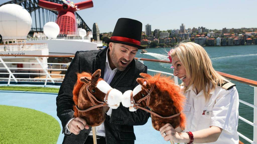 Cruise Director Eli and Senior Maitre'd Dessi compare horses on board Carnival Spirit.