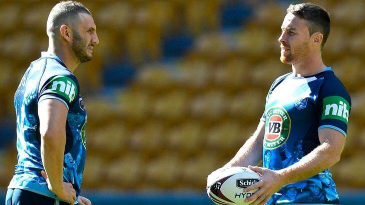 Plotting a miracle: Robbie Farah and James Maloney talk tactics at Suncorp Stadium on Tuesday. Photo: Getty Images 