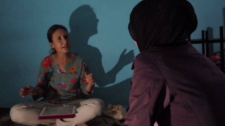Saira, right, speaks with Fairfax Media Indonesia Correspondent Jewel Topsfield at the Cisarua Refugee Learning Centre.  Photo: Dewi Nurcahyani