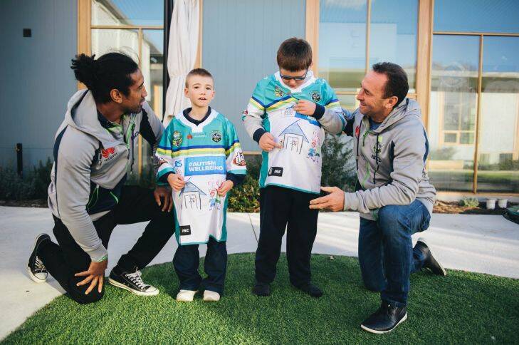 Sia Soliola and Ricky Stuart meet with Jayden, 8, and Max, 12, to give them the special jerseys they helped design.