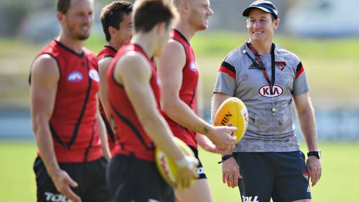 People person: Essendon coach John Worsfold with his players during a training session. Photo: Vince Caligiuri