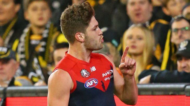 Melbourne's Tom Bugg gestures to Tigers supporters on Sunday night. Photo: Scott Barbour/AFL Media