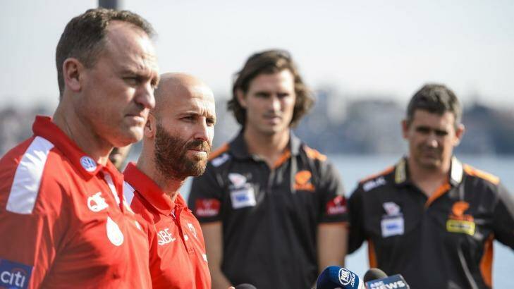 "Once the ball bounces any of those talks fall out the window straight away. Both sides are really evenly matched": John Longmire, with Swans' skipper Jarrad McVeigh, and GWS counterparts Callan Ward and Leon Cameron.  Photo: AFL Media