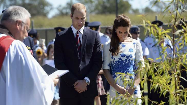 Britain's Prince William and Catherine, Duchess of Cambridge bow their heads in prayer after planting a tree at the Memorial Garden during a visit to Royal Australian Air Force (RAAF) Base Amberley near Brisbane. Photo: POOL