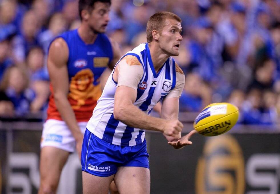 North Melbourne's Leigh Adams will consult with a neurosurgeon after suffering another concussion.  Photo: Sebastian Costanzo