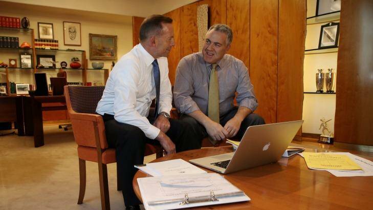 Prime Minister Tony Abbot and Treasurer Joe Hockey pore over the budget, guaranteed to surprise only its ommissions. Photo: Andrew Meares
