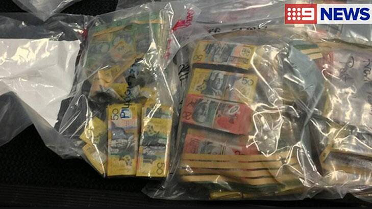 Cash seized in raids by the anti-bikie squad in Brisbane and the Gold Coast. Photo: Nine News
