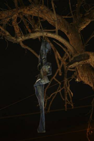 The jeans of a bombing victim hang from a burnt tree in the Karrada district of Baghdad. Photo: Kate Geraghty