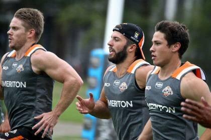 Gearing up for the season ahead: James Tedesco, centre, goes through his paces at Wests Tigers training at Concord on Monday. Photo: Ben Rushton