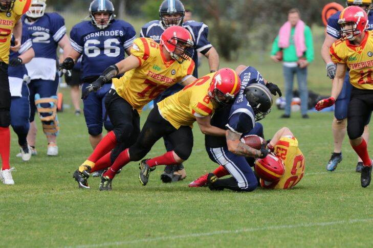 The University of Canberra Firebirds won the ACT Gridiron Capital Bowl in remarkable fashion.?? Brendan Morrissey (76),?? Max Murdoch (6), and Ian Lanham (23) make a tackle.