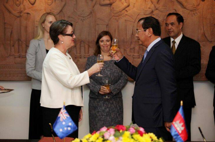 Australia's ambassador in Phnom Penh, Angela Corcoran, sings an MoU and toasts the upgrading of ties with Cambodian's Minister of Foreign Affairs Prak Sokhonn during a ceremony in Phnom Penh on Wednesday October 18 2017