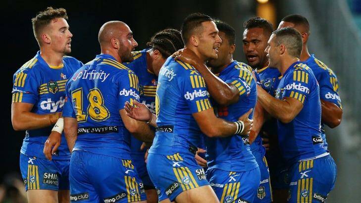 Dog catchers: Eels players celebrate a try by Brad Takairangi during the win over the Canterbury Bulldogs at ANZ Stadium. Photo: Mark Nolan