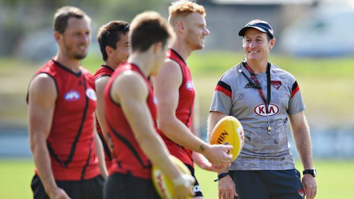 People person: Essendon coach John Worsfold talks to his players during a training session ahead of the Anzac clash with Collingwood.  Photo: Vince Caligiuri