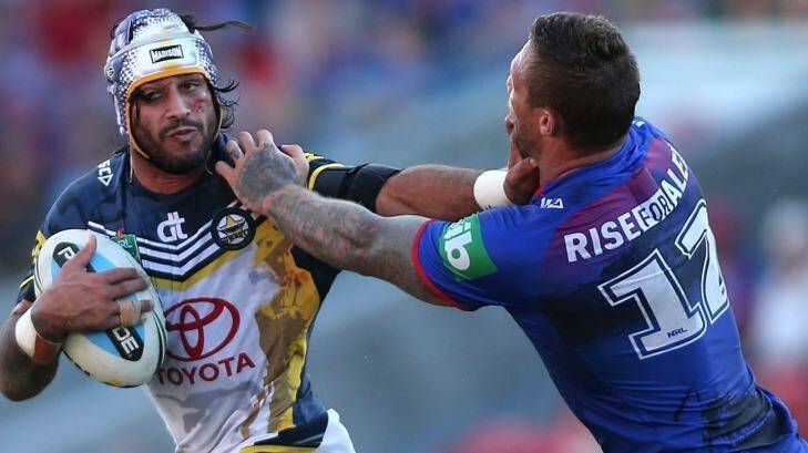 NEWCASTLE, AUSTRALIA - APRIL 25:  Johnathan Thurston of the Cowboys is tackled by Tariq Sims of the Knights  during the round eight NRL match between the Newcastle Knights and the North Queensland Cowboys at Hunter Stadium on April 25, 2015 in Newcastle, Australia.  (Photo by Tony Feder/Getty Images) Photo: Tony Feder