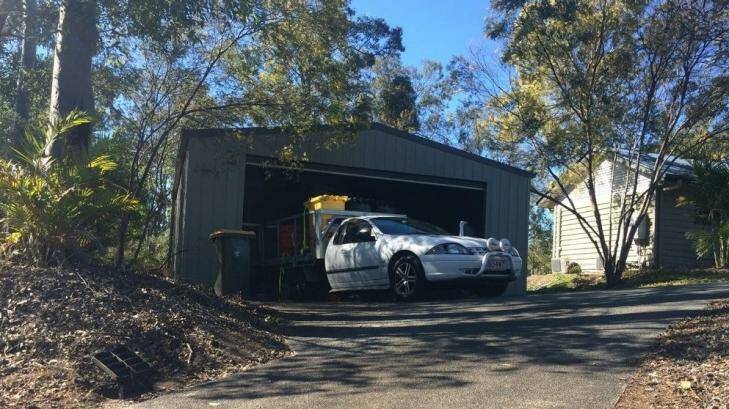 Police remove chemicals from the garage of the Pullenvale home. Photo: Josh Bavas, ABC News