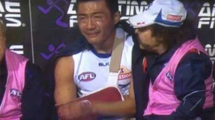 Devastated: Lin Jong on the bench after breaking his collarbone.