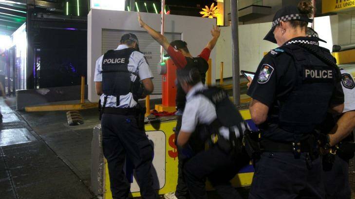 Police question a suspect at Surfers Paradise. Photo: Sahlan Hayes