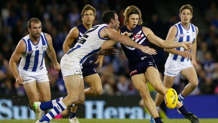 Back in Brownlow contention: Nat Fyfe of the Dockers is tackled by Todd Goldstein of the Kangaroos during the round 21 match on Sunday. Photo: AFL Media/Getty Images