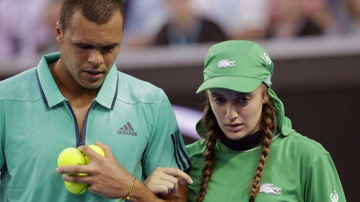 Chivalrous: Jo-Wilfried Tsonga assists a ball girl from court after she was struck on the face. Photo: Aaron Favila